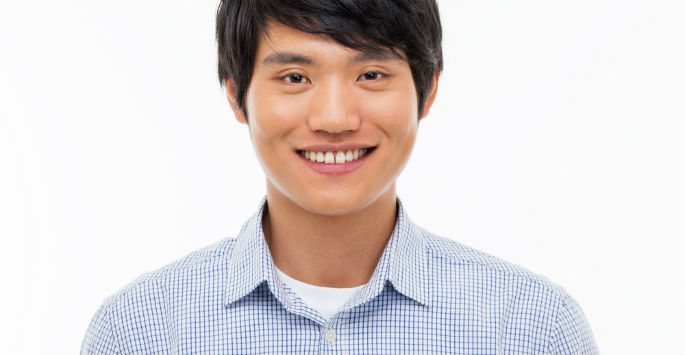 Portrait of a smiling Asian man wearing light blue polo