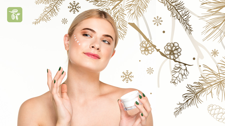 Winter themed banner photo with a female model applying skincare cream on her face