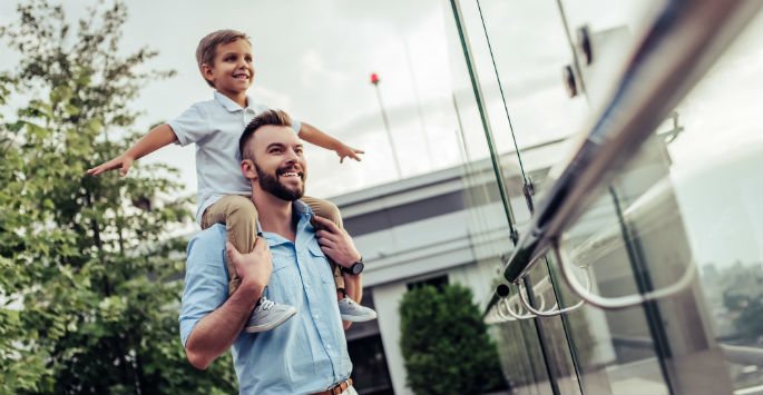 Father and son photo, the son is carried on shoulder by his dad