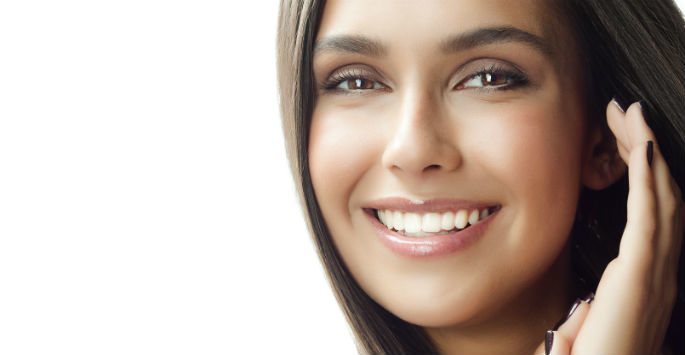 Photo of a beautiful woman against white background with big smile and hands on her ear