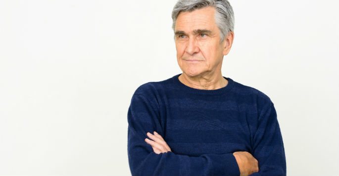 Mature man with silver hair wearing blue long sleeves