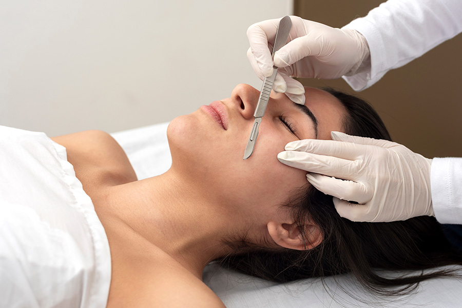 beauty center performing a dermaplaning treatment for facial skin